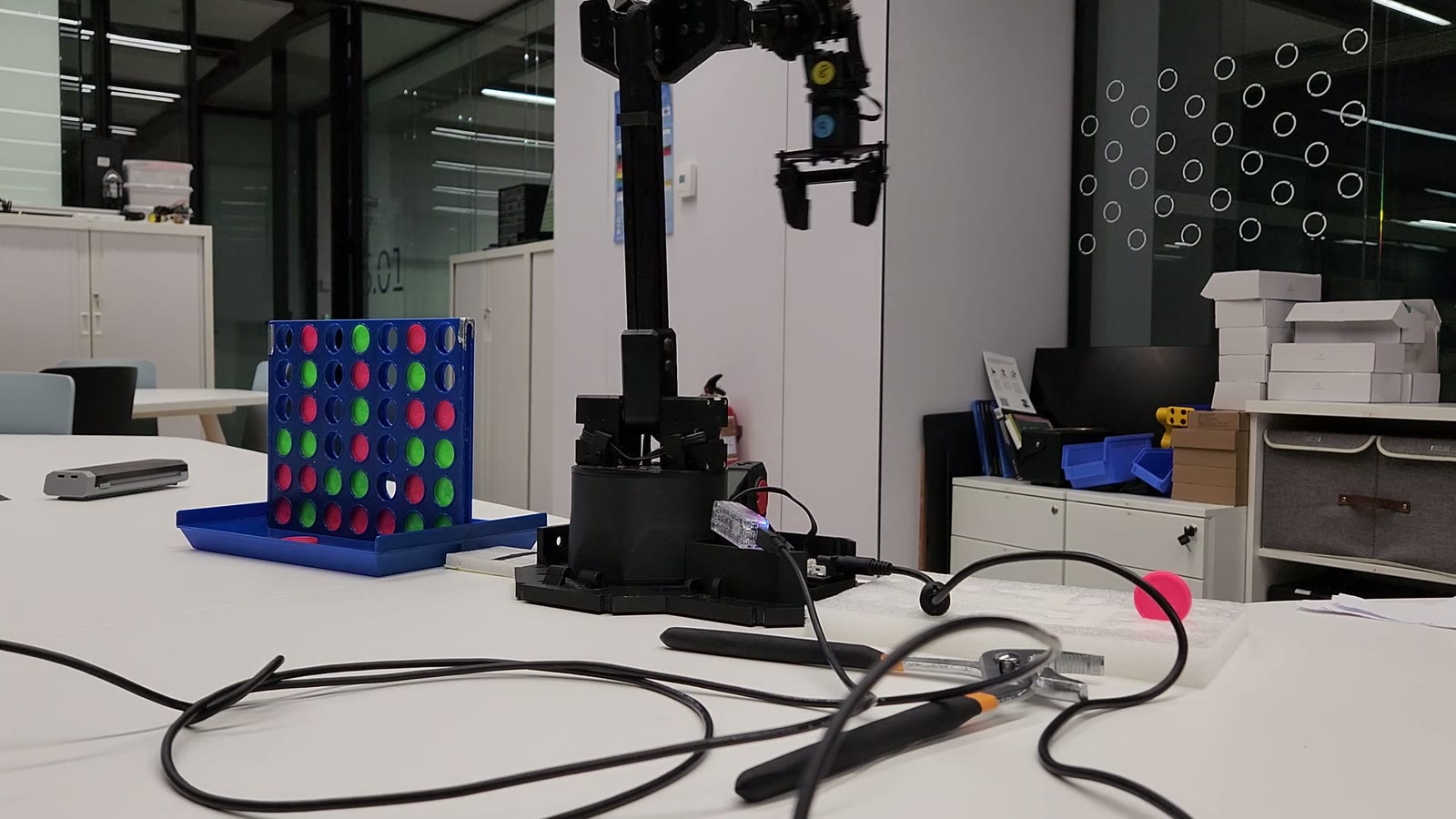 VictorIA robot arm hovering over the Connect 4 board